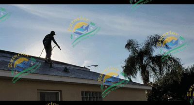 Man on roof cleaning 