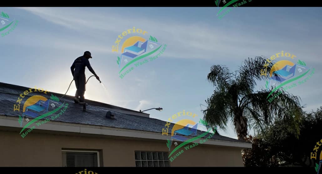 Man on roof cleaning